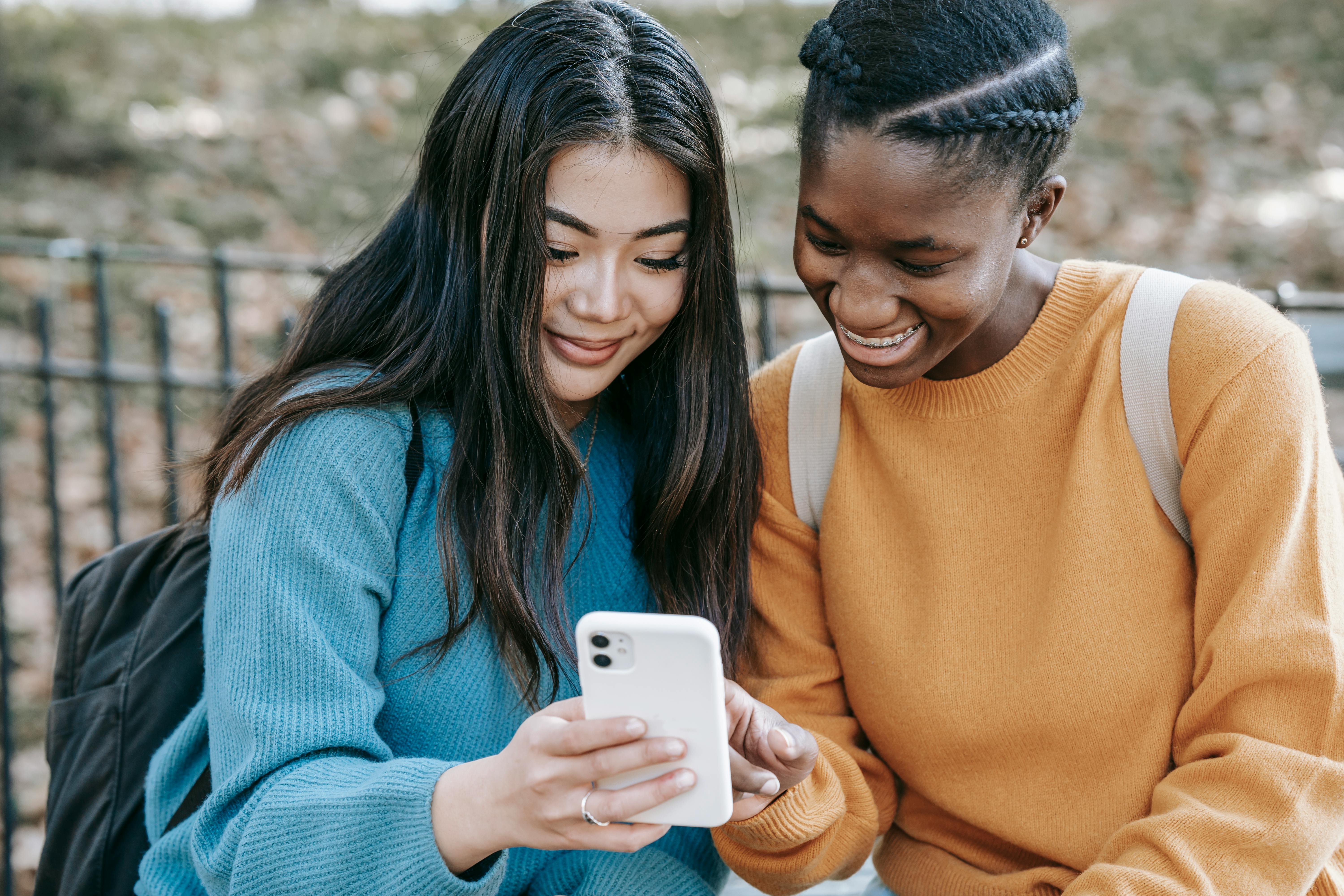 students smiling looking at phone